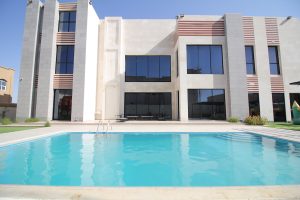 A captivating Swimming Pool Film Location showcases a serene swimming pool, gracefully positioned in front of an elegantly designed modern home