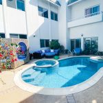 side view luxurious poolside setting featuring a pool with crystal clear blue Waterford film and photography